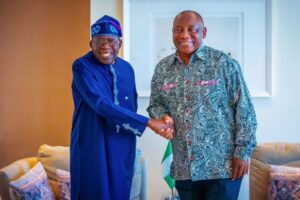 President Bola Tinubu (left) in a warm handshake with South Africa President, Cyril Ramaphosa