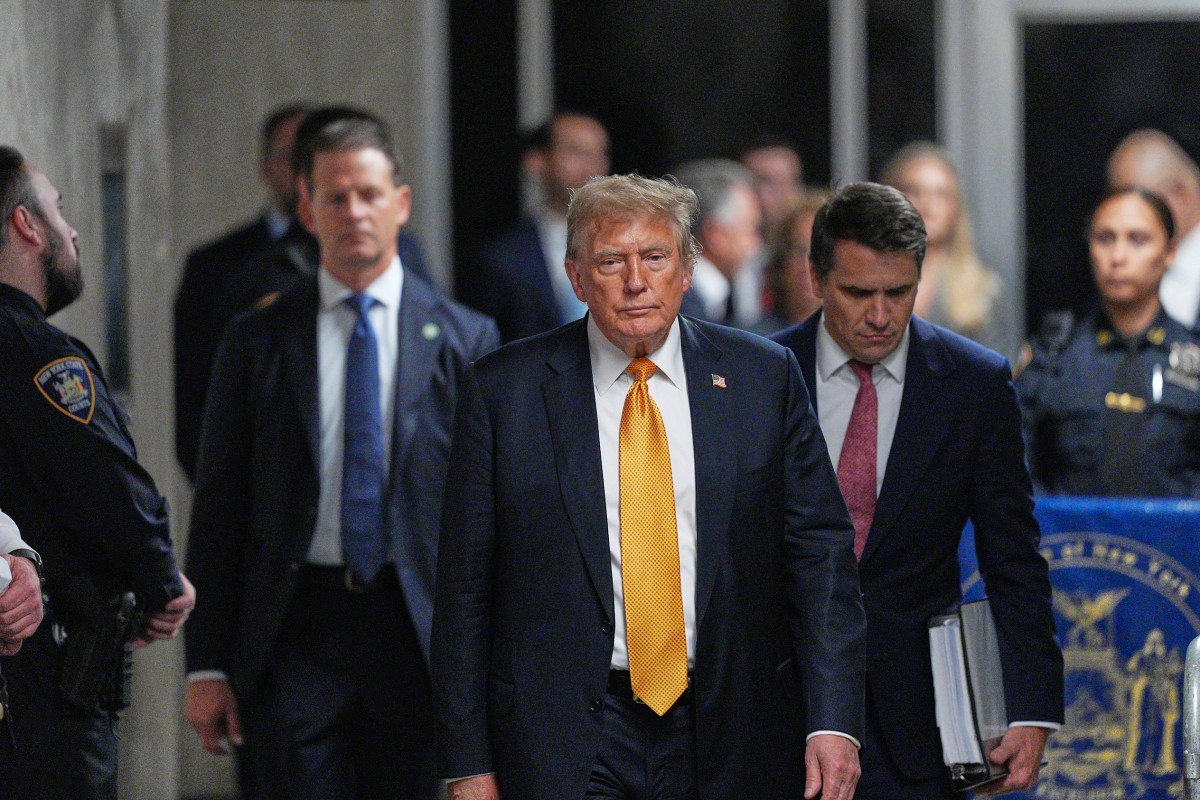 Former US President and Republican presidential candidate Donald Trump, with attorney Todd Blanche (R), walks toward the press to speak after the 12 jurors in his criminal trial began deliberating at Manhattan Criminal Court in New York City on May 29, 2024. (Photo by Curtis Means / POOL / AFP)