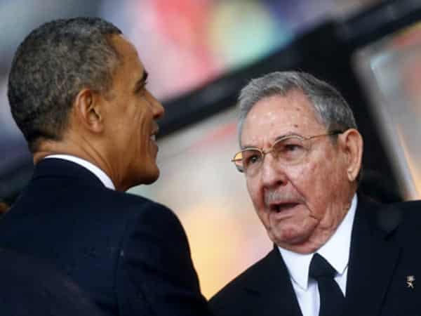 US President Obama greets Cuban President Castro at the memorial service for Nelson Mandela in Johannesburg