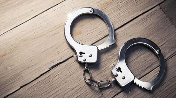 Closed handcuffs on a wooden background