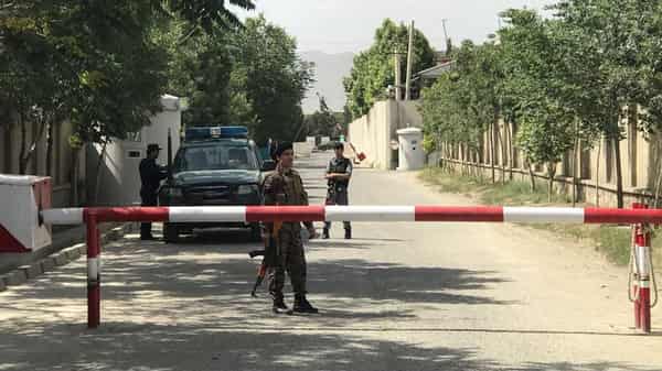 Afghan policemen keep watch near the site of a suicide attack in Kabul