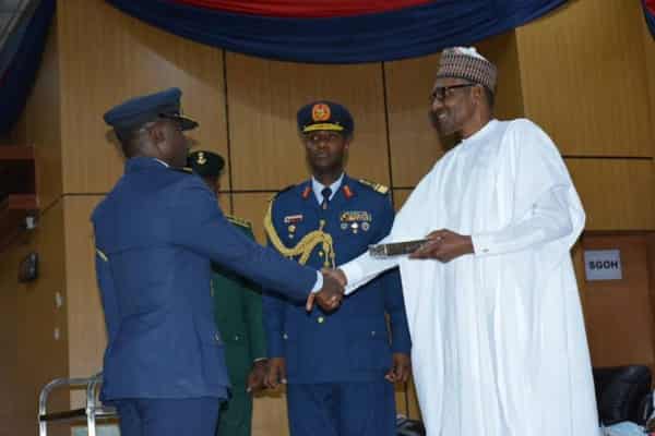 President Buhari awarding Squadron Oyenusi wit Tie of Merit in Kaduna