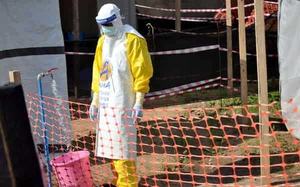 A medical worker wears a protective suit as he prepares to administer Ebola patient care at The Alliance for International Medical Action (ALIMA) treatment center in Beni