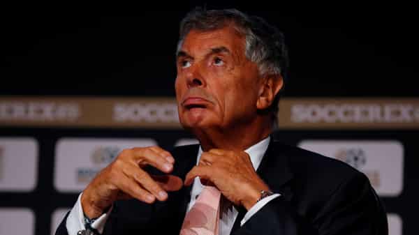 David Dein, former vice-chairman of the Football Association and Arsenal adjusts his tie ahead of a speech at the Soccerex Global Convention in Manchester, Britain