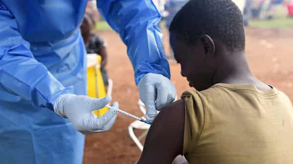 FILE PHOTO: A Congolese health worker administers Ebola vaccine to a boy who had contact with an Ebola sufferer in the village of Mangina