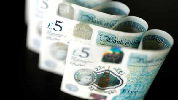 FILE PHOTO: British five pound banknotes are seen in this picture illustration