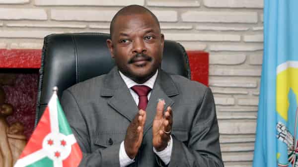 Burundi President Pierre Nkurunziza claps after signing the new constitution at the Presidential Palace in Gitega Province