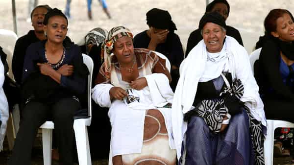 Relatives mourn at the scene of the Ethiopian Airlines Flight ET 302 plane crash, near the town Bishoftu