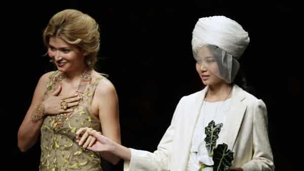 Designer Gulnara Karimova stands with a model after presenting her Guli Collection at China Fashion Week in Beijing