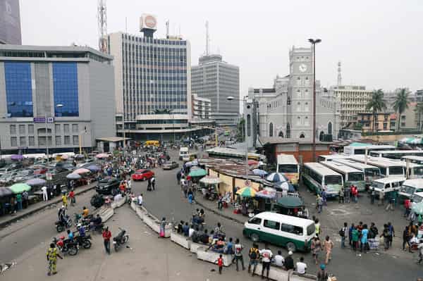 People move on a street of Marina in Victoria Island