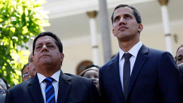 FILE PHOTO: Juan Guaido, new President of the National Constituent Assembly and lawmaker of the Venezuelan opposition party Popular Will, and lawmaker Edgar Zambrano of Democratic Action party, leave the congress in Caracas