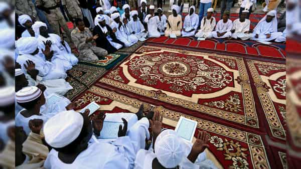 General Mohamed Hamdan Dagalo, head of the Rapid Support Forces (RSF) and deputy head of the Transitional Military Council (TMC) sits in a circle of reading Quran before iftar organized by Sultan of Darfur Ahmed Hussain in Khartoum