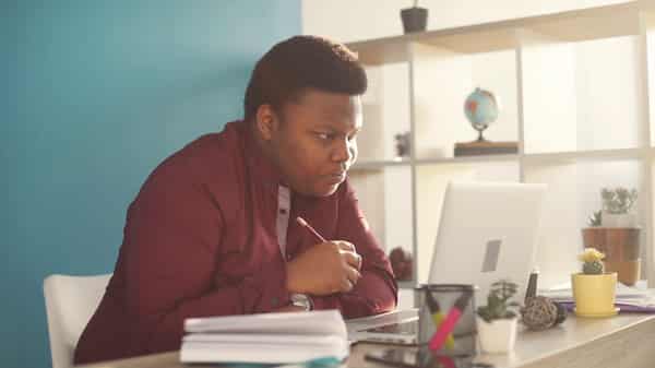 Concentrated man studying on his system. Photo Video Blocks