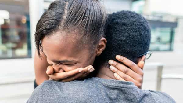 Close-up of African American young couple kissing outdoors in summer
