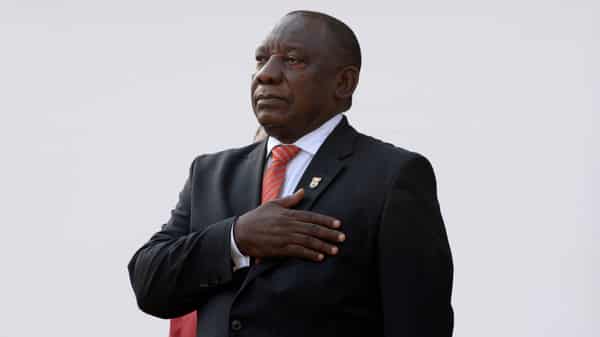 South African President Cyril Ramaphosa stands for the national anthem as he arrives to deliver his State of the Nation address at parliament in Cape Town