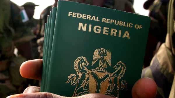 Nigerian officer holds passports for his troops about to board U.S. military plane to Darfur.