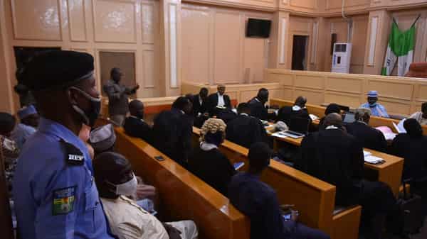 A police member stands guard as lawyers sit for an appeal hearing about a blasphemy conviction, in northern Nigeria’s Kano state