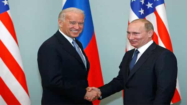 Vladimir Putin shakes and Joe Biden