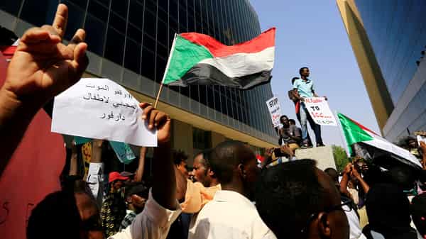 FILE PHOTO: Protesters attend a rally calling for a stop to killing in Darfur and stability for peace, next to a building in front of Ministry of Justice in Khartoum