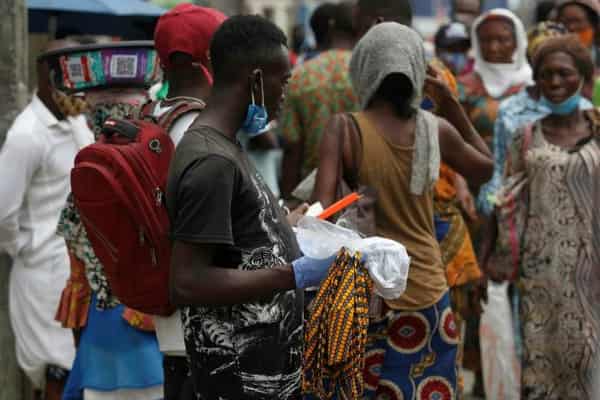 Nigerians wearing face mask on their chins Photo – Financial Times