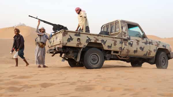 Armed men loyal to the government forces guard a site near the Safer oil fields in Marib