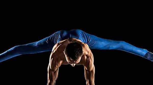Male Gymnast doing handstand on Pommel Horse