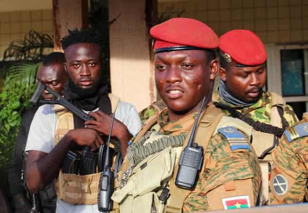 FILE PHOTO: Burkina Faso’s new military leader Ibrahim Traore is escorted by soldiers in Ouagadougou