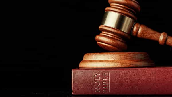 judge gavel with holy bible on black background