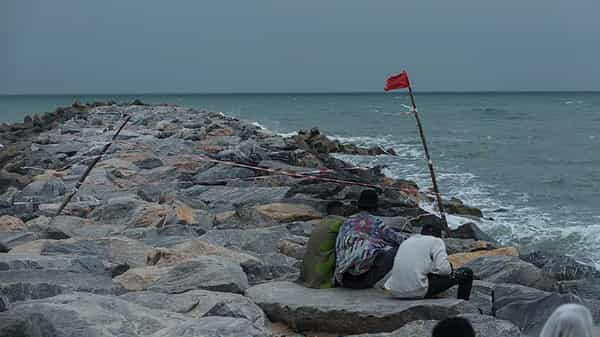 Young-people-sitting-on-wave-breaker-at-elegushi-beach