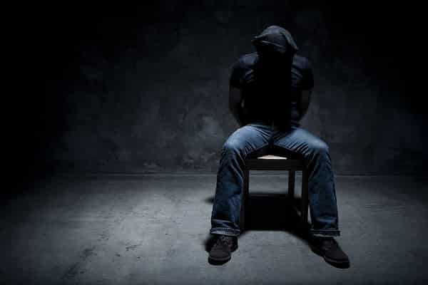 Kidnapped man in a dark room