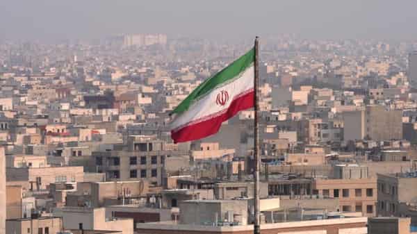 The city of Tehran with the waving Iranian Flag in the foreground