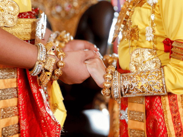 Bride_and_groom_hold_hands_during_traditional_.width-800