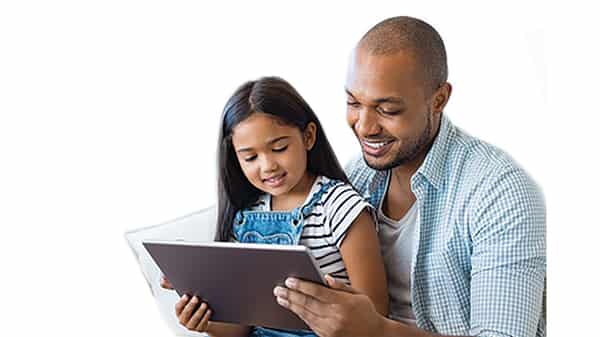 Father and daughter using tablet