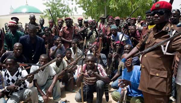 A vigilante group of traditional hunters pose for a picture at their camp in Maiduguri