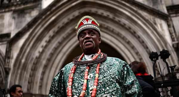 Nigerian tribal king Emere Godwin Bebe Okpabi stands outside the Royal Courts of Justice in London In February 2025 at the preliminary oil spill trial against Shell