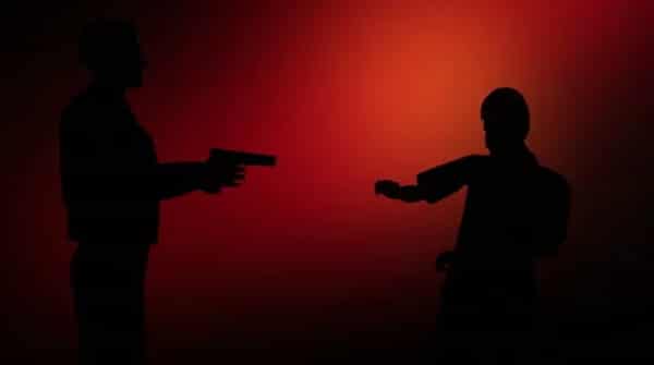 man-pointing-gun-against-flashing-footage-059713619_iconl