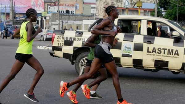 Yilmunen Nicholas the second place winner in the women’s category Ebiye David the winner in the women’s category (2nd L), and others reach Allen Avenue during the 10kilometer Capital City Race 2024 in Ikeja Lagos, Nigeria on November 23, 2024 The i