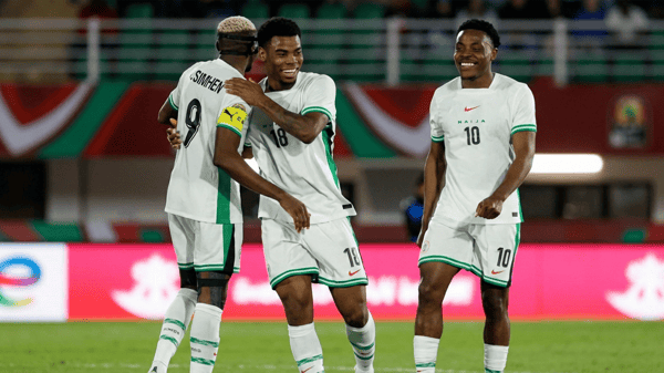 Raphael Onyedika, centre, celebrates scoring Nigeria’s third goal with Osimhen and Dele-Bashiru [AFP]