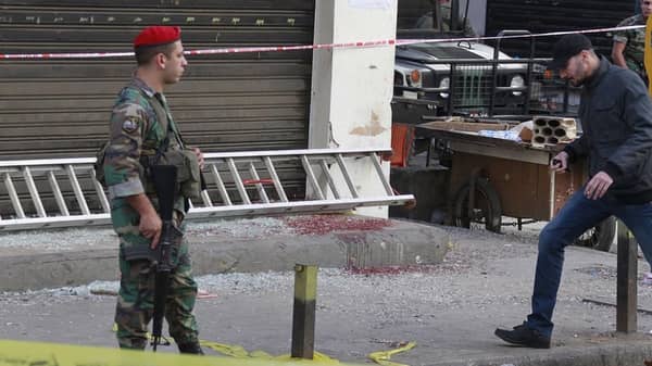Lebanese-army-soldier secures the area as blood stains are seen on the ground at the site of the two explosions that occured on Thursday in the southern suburbs of the Lebanese capital Beirut