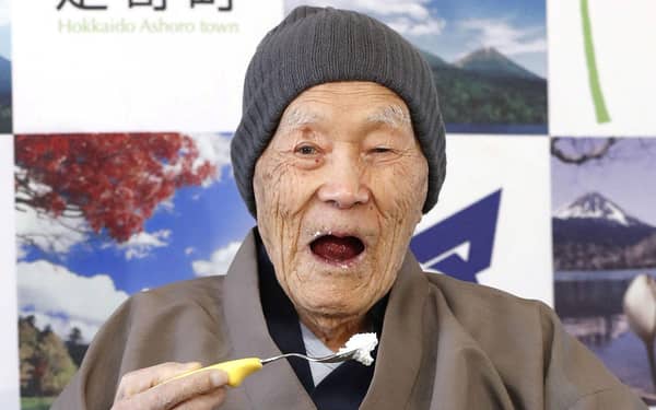 Japanese Masazo Nonaka, who was born 112 years and 259 days ago, eats his favorite cake as he receives a Guinness World Records certificate naming him the world’s oldest man during a ceremony in Ashoro