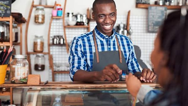 small-business-smiling-barista-standing-behind-counter-260nw-680606251