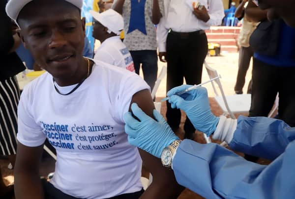 A World Health Organization worker administers a vaccination during the launch of a campaign aimed at beating an outbreak of Ebola in the port city of Mbandaka