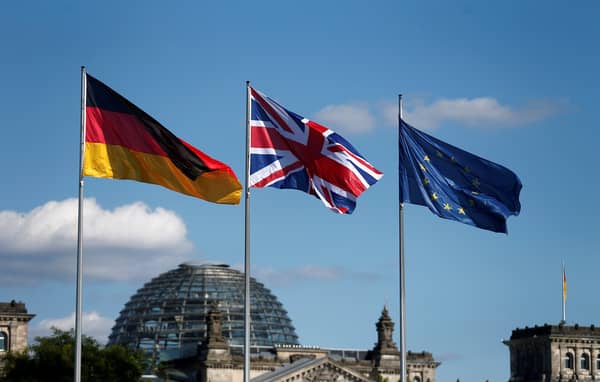 FILE PHOTO: German British and European Union flags fly in front of the Reichstag building in Berlin