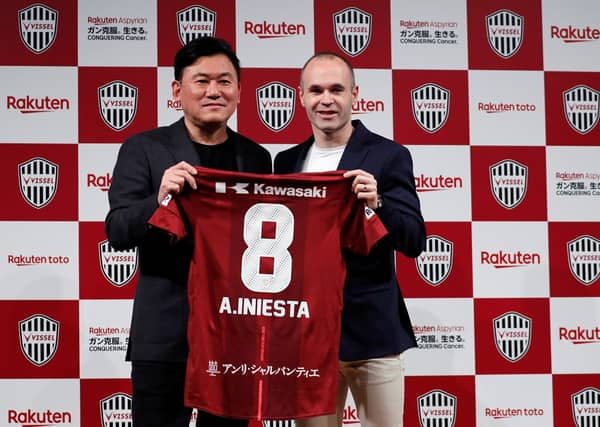 Spain midfielder Andres Iniesta poses with Hiroshi Mikitani, Chairman and CEO of Rakuten Inc and the owner of Vissel Kobe, at a news conference to announce signing for J-League side Vissel Kobe in Tokyo