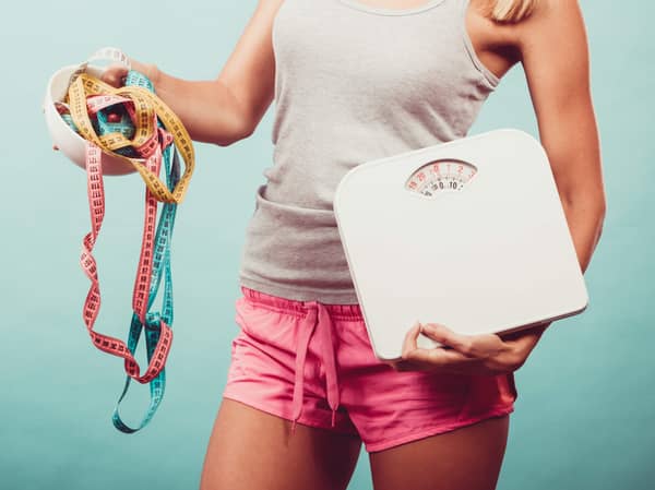 Girl with scales measuring tapes. Weight loss.