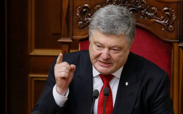 Ukrainian President Petro Poroshenko addresses lawmakers after voting on a law to establish an anti-corruption court during a parliament session in Kiev
