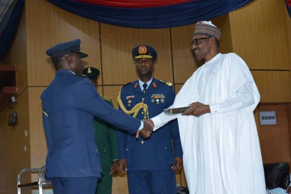 President Buhari awarding Squadron Oyenusi wit Tie of Merit in Kaduna