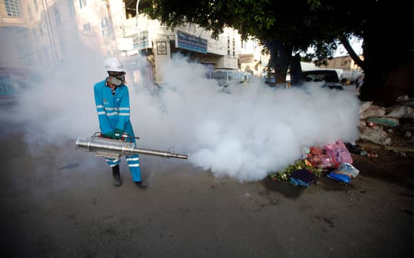 Public health workers spray insecticide amid fears of a new cholera outbreak in Sanaa