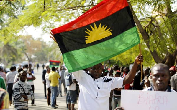A supporter of Indigenous People of Biafra (IPOB) leader Nnamdi Kanu holds a Biafra flag during a rally in support of Kanu, who is expected to appear at a magistrate court in Abuja