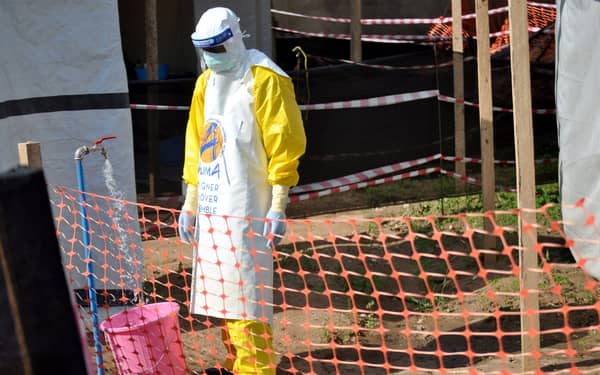 A medical worker wears a protective suit as he prepares to administer Ebola patient care at The Alliance for International Medical Action (ALIMA) treatment center in Beni